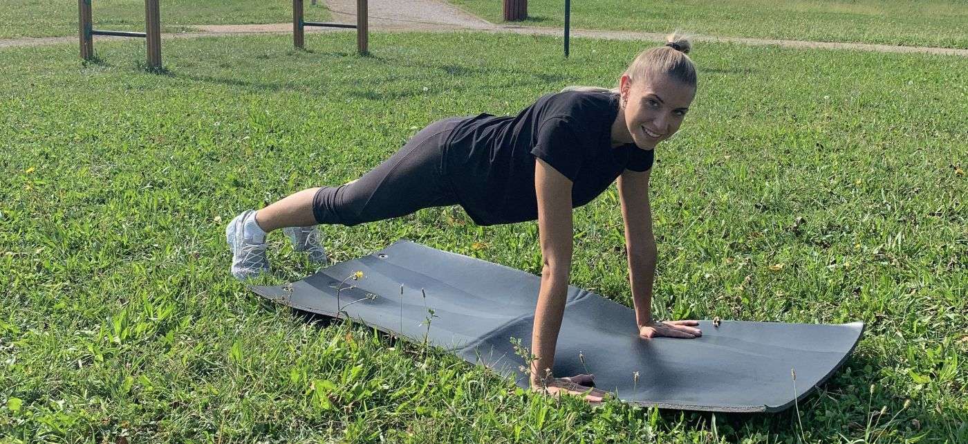 Allenamento outdoor a corpo libero su tappetino in un parco