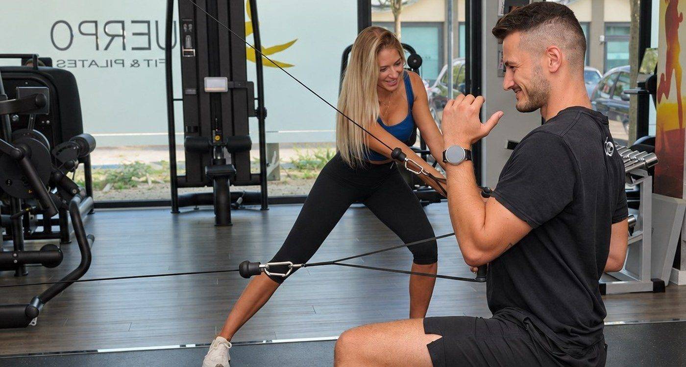 Personal trainer e cliente si allenano con i cavi Kinesis